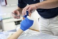 Doctor bandaging plaster cast to kids broken hand bone in hospital Royalty Free Stock Photo