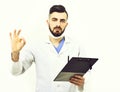 Doctor with beard holds clip folder for prescriptions