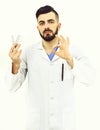 Doctor with beard holds pills blisters and shows ok sign