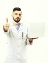 Doctor with beard holds white laptop and shows thumbs up