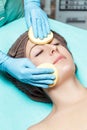 Doctor beautician cleanses skin woman with sponge. cosmetology treatment skincare face. Spa procedures Royalty Free Stock Photo