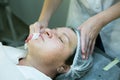 A visit to a beautician. Doctor beautician prepares the patient`s face for the procedure - carboxytherapy. The preparatory stage