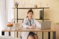 Doctor beautiful asian women sitting and working on desk using laptop and writing note at hospital,Female typing on laptop compute Royalty Free Stock Photo