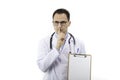 Doctor with blank clipboard making silence gesture. Medical confidentiality Royalty Free Stock Photo