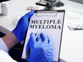 Doctor in gloves reads about Multiple myeloma Royalty Free Stock Photo