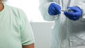 Doctor in blue latex gloves fill in syringe with medicine from glass vial for injection of an elderly person in medical Royalty Free Stock Photo