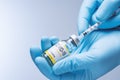 Doctor in blue latex gloves fill in syringe with vaccine from glass vial. Vaccination, immunization, treatment to Covid 19 Corona Royalty Free Stock Photo
