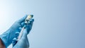 Doctor in blue latex gloves fill in syringe with vaccine from glass vial. Vaccination, immunization, treatment to Covid 19 Corona Royalty Free Stock Photo