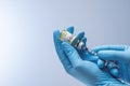 Doctor in blue latex gloves fill in syringe with vaccine from glass vial. Royalty Free Stock Photo