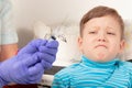 doctor in blue medical gloves injects a sick child with a syringe