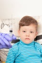 doctor in blue medical gloves injects a sick child with a syringe