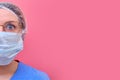 A doctor in a blue uniform on a pink background with a frightened look, copy space for text. Half face of a nurse with glasses,