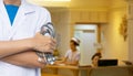 Doctor with blurred hospital counter and nurses. Royalty Free Stock Photo