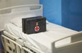 Doctor box bag on hospital bed with copy space in covid 19 medical concept