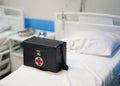 Doctor box bag on hospital bed with copy space in covid 19 medical concept