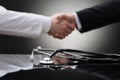 Doctor and businessman shaking hand