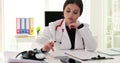 Doctor calculates costs and income for medical expenses