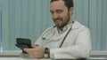 Sinister bearded doctor with a calculator. calculation of price