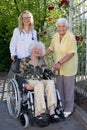 Doctor, Caregiver and Elderly Smiling at Camera Royalty Free Stock Photo