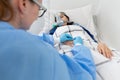 The doctor changes the dressing and changes the venflon. A seriously ill teenager lies on a hospital bed Royalty Free Stock Photo