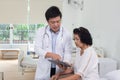 Doctor in charge of an elderly nursing home center is examining an elderly person in health care center Royalty Free Stock Photo