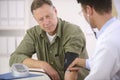 Doctor checking blood pressure Royalty Free Stock Photo