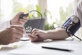 Doctor measuring blood pressure of patient