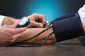 Doctor Checking Blood Pressure Of Patient At Table Royalty Free Stock Photo