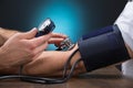 Doctor Checking Blood Pressure Of Patient At Table Royalty Free Stock Photo