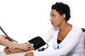 Doctor checking blood pressure of pregnant woman.