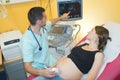 doctor checking echography pregnant woman in clinic