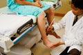 Doctor checking foot reflexes Royalty Free Stock Photo