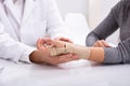 Doctor Checking Fractured Hand Of A Woman Royalty Free Stock Photo