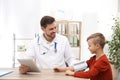 Doctor checking little boy`s pulse with medical device Royalty Free Stock Photo