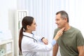 Doctor checking mature man`s pulse with fingers Royalty Free Stock Photo