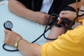 Doctor checking old woman patient arterial blood pressure, close-up Royalty Free Stock Photo