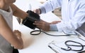 Doctor checking old woman patient arterial blood pressure. Health care. Royalty Free Stock Photo