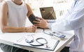 Doctor checking old woman patient arterial blood pressure. Health care Royalty Free Stock Photo