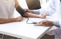 Doctor checking old woman patient arterial blood pressure. Health care. Royalty Free Stock Photo