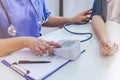 Doctor checking old woman patient arterial blood pressure. Health care Royalty Free Stock Photo