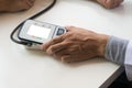 Doctor checking old woman patient arterial blood pressure. Health care. Royalty Free Stock Photo