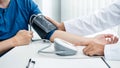 Doctor is checking the patient blood pressure in his hospital office Royalty Free Stock Photo