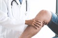 Doctor checking patient with knees to determine the cause of ill Royalty Free Stock Photo