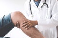 Doctor checking patient with knees to determine the cause of ill Royalty Free Stock Photo