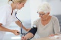 Doctor checking on patient's blood pressure