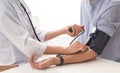 Doctor checking patient`s blood pressure in hospital, closeup. Royalty Free Stock Photo