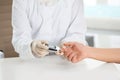 Doctor checking patient`s blood sugar level with digital glucometer at table, closeup. Royalty Free Stock Photo