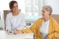 Doctor checking patient`s blood sugar level with digital glucometer at table Royalty Free Stock Photo