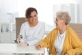 Doctor checking patient`s blood sugar level with digital glucometer at table Royalty Free Stock Photo