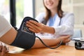 A doctor checking patient's pulse and blood pressure with a monitor in the examination room Royalty Free Stock Photo